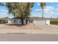 Charming single-story home with a well-manicured front yard and attached two-car garage at 419 N Valencia Dr, Chandler, AZ 85226