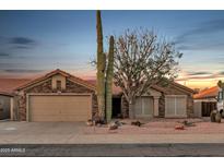 Charming single-story home with desert landscaping and a two-car garage under a beautiful sunset sky at 446 W Sereno Dr, Gilbert, AZ 85233