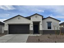 Inviting single-story home featuring a two-car garage and neutral-toned stucco, and low-maintenance desert landscaping at 5758 E Smeaton Pl, San Tan Valley, AZ 85140