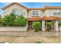 Charming townhome featuring a red tile roof, stucco siding, and well-maintained landscaping at 5808 E Brown Rd # 106, Mesa, AZ 85205