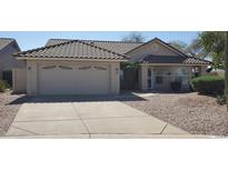 Charming single-story home with a two-car garage and meticulously maintained desert landscaping at 6005 E Selkirk Cir, Mesa, AZ 85215