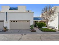 Charming home exterior featuring a beige garage, blue roof accents, and well-maintained landscaping at 10 W Georgia Ave # 8, Phoenix, AZ 85013