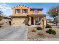 Charming two-story home with desert landscaping and a cozy front porch area at 18040 W Louise Dr, Surprise, AZ 85387