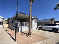 Charming single-story home with well-maintained landscaping and a covered porch at 2070 W Klamath Ave, Apache Junction, AZ 85119