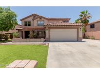 Inviting two-story home featuring a two-car garage, well-manicured lawn, and a charming covered porch at 3397 E Derringer Way, Gilbert, AZ 85297
