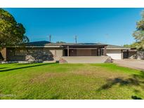 Charming single-story home featuring well-kept front yard and covered porch with stone accents at 346 E Highland Ave, Phoenix, AZ 85012