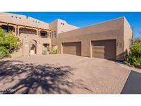 Inviting two-story home featuring a private entry and a spacious two-car garage at 36601 N Mule Train Rd # B14, Carefree, AZ 85377