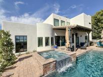 Modern backyard featuring a pool with integrated hot tub, patio, and beautiful white stucco home at 3811 N 64Th St, Scottsdale, AZ 85251