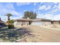 Charming single-story home with an attached garage, desert landscaping and a circular driveway at 5142 E Edgewood Cir, Mesa, AZ 85206