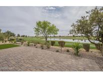 Paver patio overlooking the lake and golf course provides great outdoor space and relaxing views at 583 E Peach Tree St, Queen Creek, AZ 85140