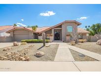 Charming single-story home with desert landscaping and a red tile roof at 9637 E Cochise Dr, Scottsdale, AZ 85258