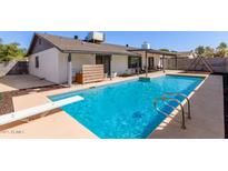 Backyard pool with diving board, seating area, and covered patio for relaxing and entertaining at 1311 W Palo Verde Dr, Chandler, AZ 85224
