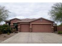 Inviting single-story home featuring a three-car garage and desert landscaping for low maintenance appeal at 13146 S 178Th Ave, Goodyear, AZ 85338