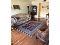 Cozy living room featuring hardwood floors, an area rug, and traditional furnishings and decor at 1713 W Royal Palm Rd, Phoenix, AZ 85021