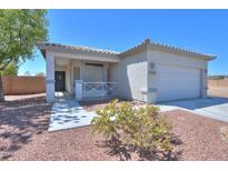 Well-maintained home featuring desert landscaping, a welcoming front porch, and a two-car garage at 1825 E Sycamore Rd, Casa Grande, AZ 85122