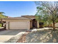 Charming single-story home showcasing desert landscaping, a spacious two-car garage, and a welcoming facade at 18665 N 70Th Dr, Glendale, AZ 85308