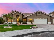Inviting single-story home featuring a tile roof, desert landscaping, and a two-car garage at 21 W Pecan Pl, Tempe, AZ 85284