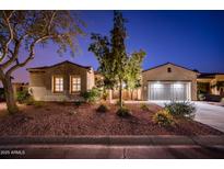 Charming single-story home with well-manicured landscaping and a two-car garage at twilight at 23116 N Del Monte Dr, Sun City West, AZ 85375