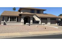 Charming home featuring a covered entry, manicured gravel yard, and attached two-car garage at 2634 E Fountain St, Mesa, AZ 85213