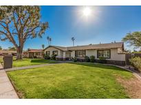 Well-manicured front yard with green lawn and a brick pathway to the home at 3016 N 49Th St, Phoenix, AZ 85018