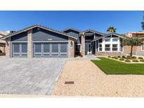 Charming single-Gathering home featuring a three-car garage, manicured landscaping, and modern design at 4536 E Beck Ln, Phoenix, AZ 85032
