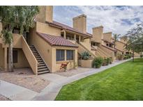 Charming townhome featuring traditional Southwest architecture, red tile roof, and well-maintained landscaping at 4901 S Calle Los Cerros Dr # 236, Tempe, AZ 85282