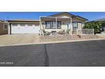 Charming single-story home with a two-car garage, front patio, and desert landscaping at 650 N Hawes Rd # 4406, Mesa, AZ 85207