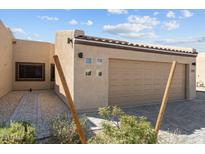 Inviting home exterior with attached two-car garage and well maintained desert landscaping at 701 Dylan Ct, Wickenburg, AZ 85390