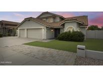 Charming home features a three-car garage, manicured lawn, and lush landscaping, enhancing its curb appeal at 16458 N 56Th Way, Scottsdale, AZ 85254