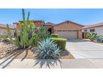 Charming home featuring desert landscaping, rock accents, and a two-car garage at 17743 W Verdin Rd, Goodyear, AZ 85338