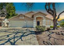 Charming single-story home features a three-car garage and a well-maintained front yard with desert landscaping at 20615 N 55Th Ave, Glendale, AZ 85308