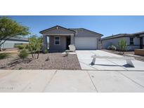 Charming single-story home featuring a well-maintained yard and attached two-car garage at 35295 W La Paz St, Maricopa, AZ 85138