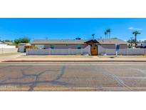 Charming single-story home with a welcoming front yard and a secure, wooden gate at 3601 N 12Th St, Phoenix, AZ 85014