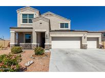 Charming two-story home featuring a spacious three-car garage and manicured landscaping at 3932 N 306Th Ln, Buckeye, AZ 85396