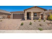 Charming single-story home featuring a two-car garage and desert landscaping at 40546 W Michaels Dr, Maricopa, AZ 85138