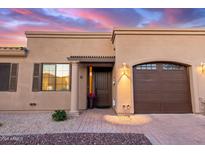 Charming home featuring a well-manicured front yard, a private garage, and an inviting entryway at 4241 N Pebble Creek Pkwy # 28, Goodyear, AZ 85395