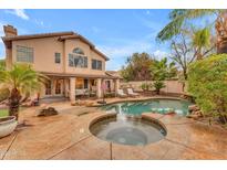 Resort-style pool and spa area with lush landscaping and a basketball hoop, perfect for outdoor relaxation and fun at 5615 W Tonopah Dr, Glendale, AZ 85308