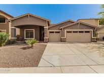 Charming single-story home featuring a three-car garage and desert landscaping at 6829 S 58Th Ave, Laveen, AZ 85339