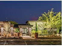 Striking front exterior with stone accents, manicured landscaping, and exterior lighting at 9515 N 47Th St, Phoenix, AZ 85028