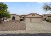 Charming single-story home featuring a three-car garage and well-maintained desert landscaping at 9821 E Glencove St, Mesa, AZ 85207