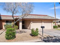 Charming single-story home featuring a tile roof, desert landscaping, and attached two-car garage at 11604 S Ki Rd, Phoenix, AZ 85044