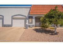 Charming single-story home with a well-manicured front yard and attached one car garage at 1951 N 64Th St # 26, Mesa, AZ 85205