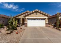 Charming home featuring a two-car garage, desert landscaping, and a warm, inviting facade at 202 W Twin Peaks Pkwy, San Tan Valley, AZ 85143