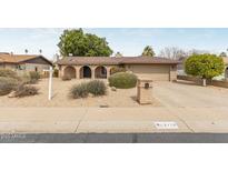 Charming single-story brick home with a well-maintained desert landscape and arched entryway at 2110 E Laguna Dr, Tempe, AZ 85282