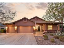 Charming home with a three-car garage, well-manicured landscaping, and inviting front entrance at 3482 E Cotton Ln, Gilbert, AZ 85234