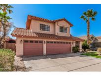 Charming two-story home featuring a tile roof, a spacious driveway and a two-car garage at 4931 E Paradise Ln, Scottsdale, AZ 85254