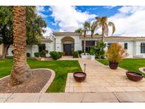 Beautiful home exterior with well-manicured lawn, mature trees, and an inviting front entrance at 5127 N 71St St, Paradise Valley, AZ 85253