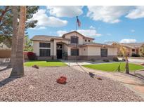 Charming two-story home with well manicured lawn and desert landscaping at 5613 W West Wind Dr, Glendale, AZ 85310