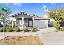 Charming single-story home with a well-manicured lawn, inviting covered porch, and two-car garage at 10144 E Thistle Ave, Mesa, AZ 85212