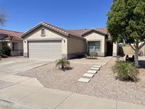 Charming single-story home featuring a well-manicured yard and attached two-car garage at 11342 E Queensborough Ave, Mesa, AZ 85212